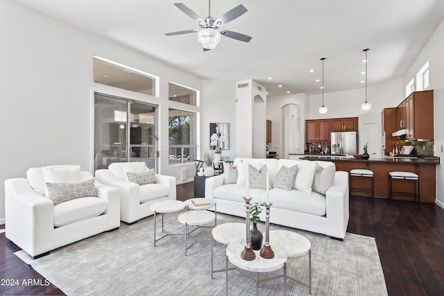 living room featuring ceiling fan and dark hardwood / wood-style flooring