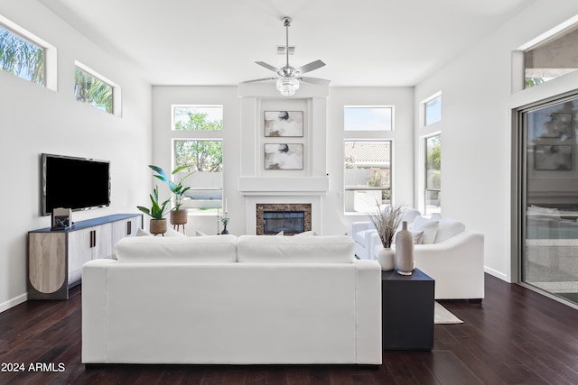 living room with ceiling fan, a healthy amount of sunlight, and dark wood-type flooring