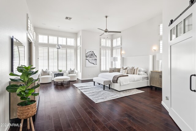 bedroom with dark hardwood / wood-style flooring, multiple windows, and ceiling fan