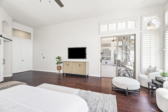 bedroom with access to exterior, ceiling fan, and dark wood-type flooring