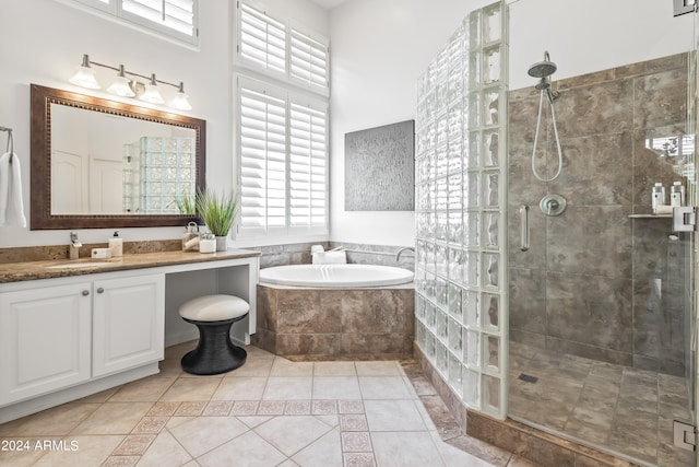 bathroom featuring tile patterned flooring, vanity, and independent shower and bath