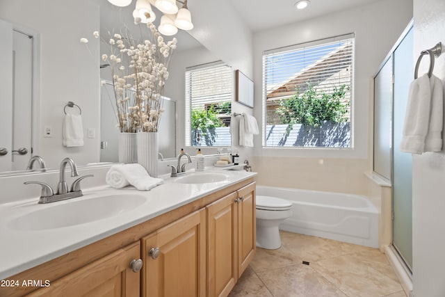 full bathroom featuring vanity, tile patterned floors, toilet, shower with separate bathtub, and a chandelier