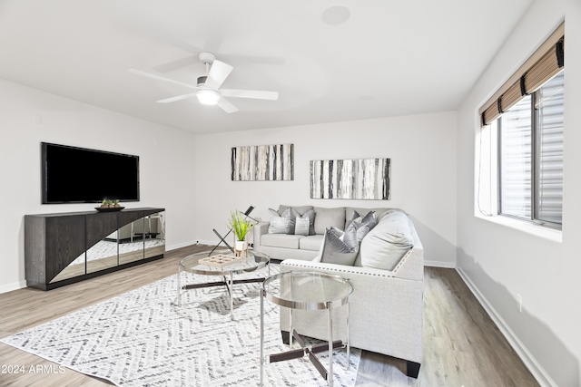 living room with wood-type flooring and ceiling fan
