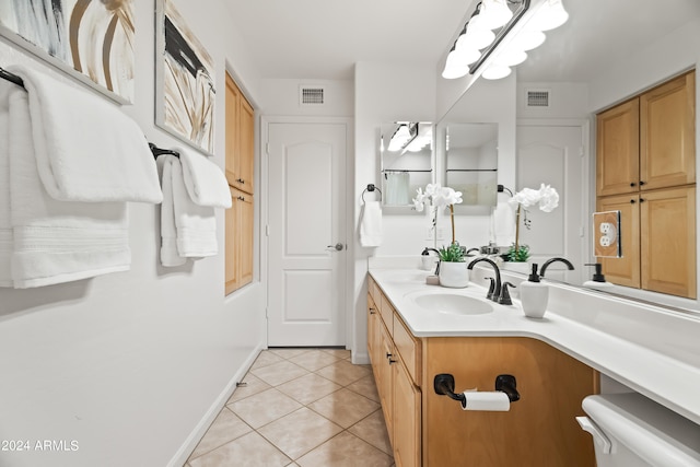 bathroom featuring tile patterned flooring, vanity, and toilet