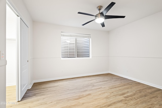 unfurnished bedroom with ceiling fan and light hardwood / wood-style flooring