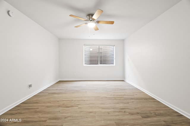 spare room featuring light hardwood / wood-style floors and ceiling fan