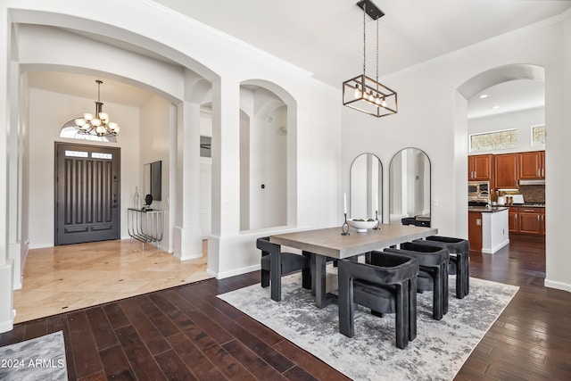 dining space featuring a notable chandelier and dark hardwood / wood-style floors