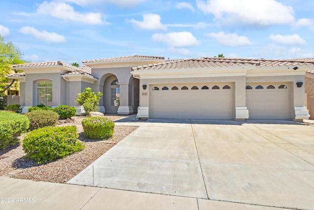 mediterranean / spanish home with a garage