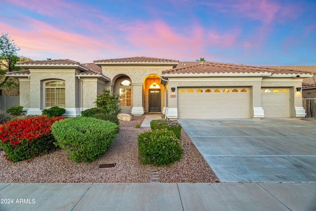 mediterranean / spanish house featuring a garage