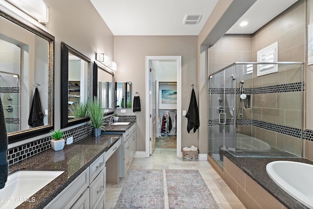 bathroom with vanity, shower with separate bathtub, and backsplash