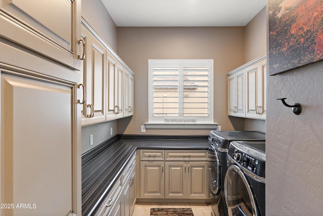 washroom with cabinets, separate washer and dryer, and light tile patterned floors