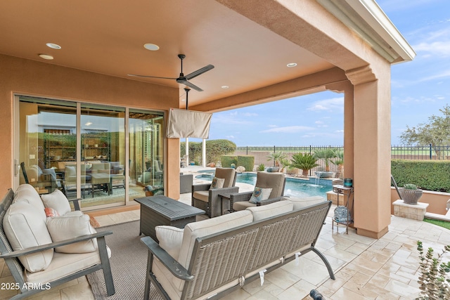 view of patio with a fenced in pool, outdoor lounge area, pool water feature, and ceiling fan