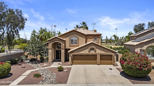 1244 W Straford Ave, Gilbert, AZ 85233 - mediterranean / spanish-style house featuring a garage, driveway, a tile roof, and stucco siding