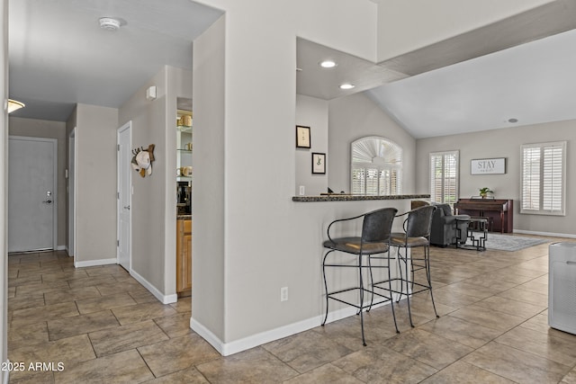 1244 W Straford Ave, Gilbert, AZ 85233 - kitchen featuring a breakfast bar area, baseboards, lofted ceiling, recessed lighting, and a peninsula