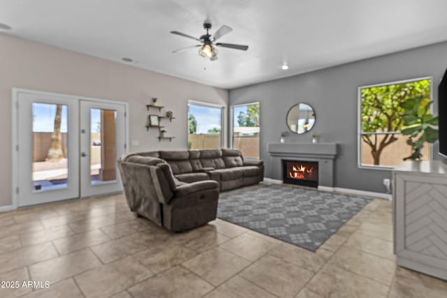 1244 W Straford Ave, Gilbert, AZ 85233 - living room featuring ceiling fan, a lit fireplace, baseboards, and french doors