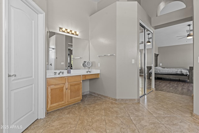 1244 W Straford Ave, Gilbert, AZ 85233 - bathroom featuring vanity, a ceiling fan, connected bathroom, and baseboards