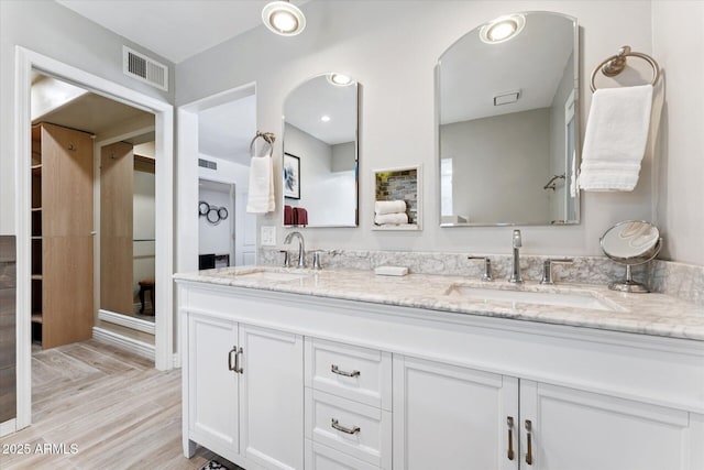 7835 E Cannon Dr, Scottsdale, AZ 85258 - bathroom featuring double vanity and wood finished floors