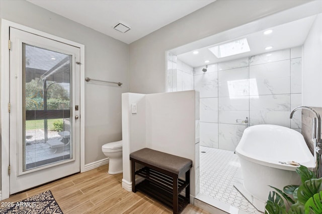7835 E Cannon Dr, Scottsdale, AZ 85258 - full bath with a skylight, a freestanding tub, wood finished floors, a walk in shower, and recessed lighting