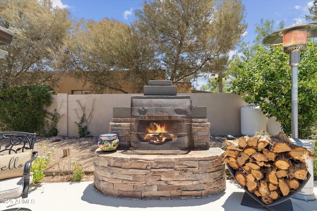 7835 E Cannon Dr, Scottsdale, AZ 85258 - view of patio / terrace featuring an outdoor stone fireplace