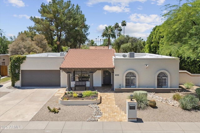 7835 E Cannon Dr, Scottsdale, AZ 85258 - mediterranean / spanish-style home featuring stucco siding, a garage, concrete driveway, a tiled roof, and a chimney