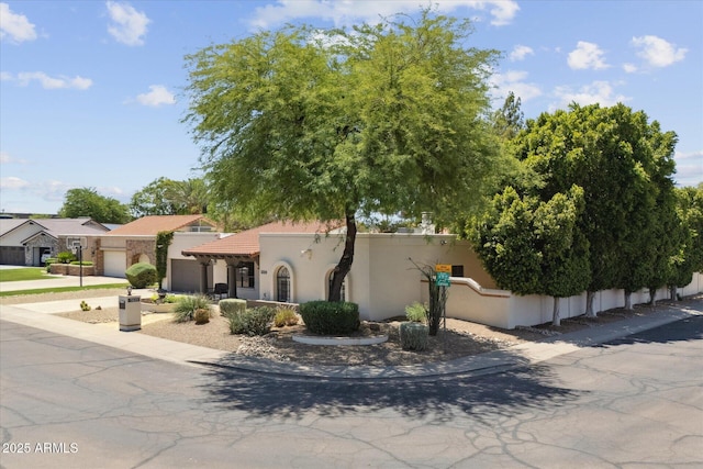 7835 E Cannon Dr, Scottsdale, AZ 85258 - view of front of house with an attached garage, stucco siding, driveway, and a tiled roof
