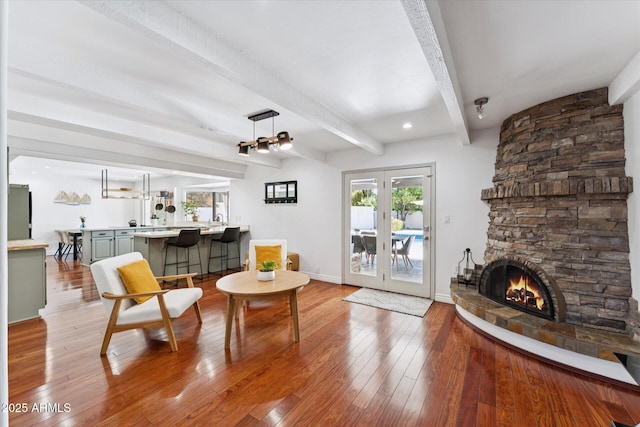 7835 E Cannon Dr, Scottsdale, AZ 85258 - living area with beamed ceiling, a fireplace, and hardwood / wood-style flooring