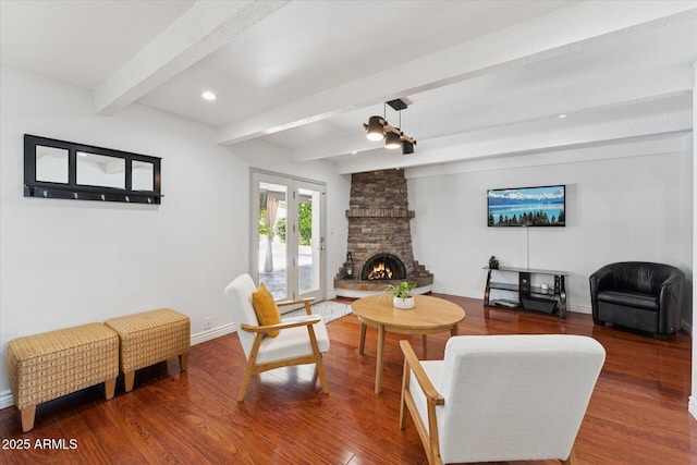7835 E Cannon Dr, Scottsdale, AZ 85258 - living area with beamed ceiling, wood finished floors, a stone fireplace, and recessed lighting
