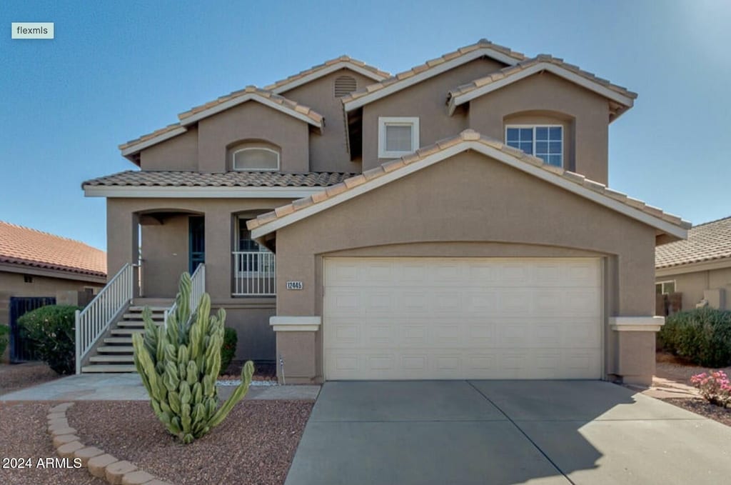 mediterranean / spanish-style house featuring a garage and a porch