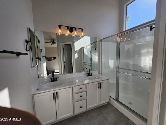 bathroom featuring ceiling fan, vanity, and a shower with door