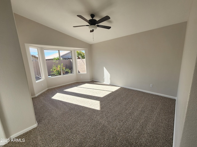 carpeted spare room with vaulted ceiling and ceiling fan