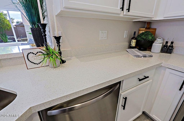 kitchen with dishwasher, a wealth of natural light, and white cabinets