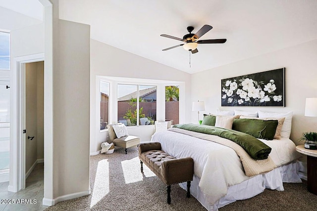 carpeted bedroom with ceiling fan and lofted ceiling