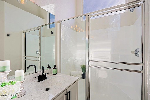 bathroom with an enclosed shower and vanity