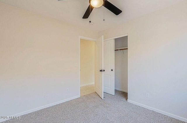 unfurnished bedroom with light colored carpet, a closet, and ceiling fan