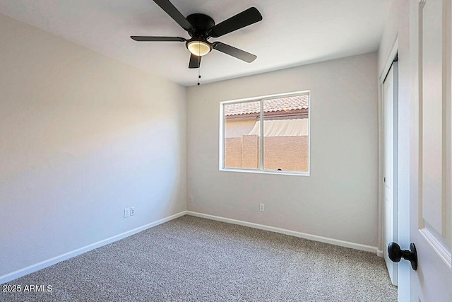 spare room featuring ceiling fan and carpet floors