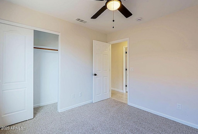 unfurnished bedroom with ceiling fan, a closet, and carpet