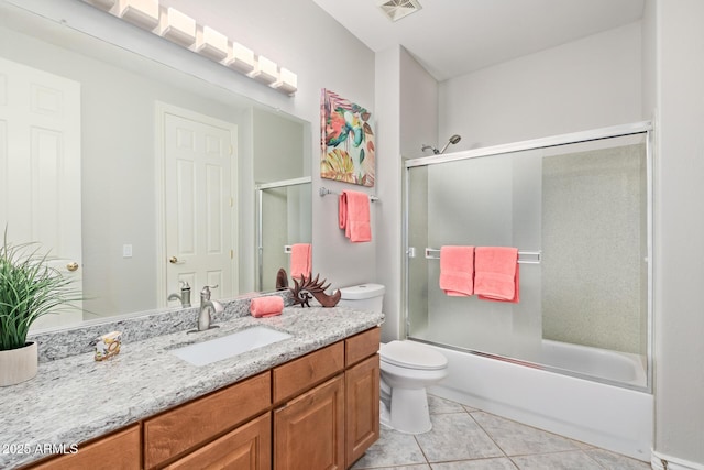 full bathroom with visible vents, vanity, toilet, bath / shower combo with glass door, and tile patterned floors