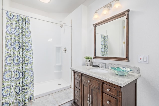 full bath featuring curtained shower, tile patterned flooring, and vanity
