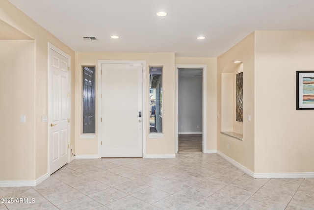 foyer with light tile patterned floors, baseboards, recessed lighting, and visible vents