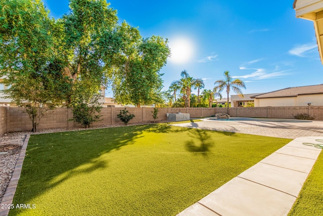 view of yard featuring a patio, a fenced in pool, and a fenced backyard