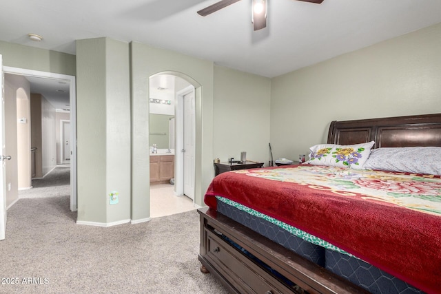 45 S 238th Dr, Buckeye, AZ 85396 - bedroom featuring arched walkways, ensuite bathroom, baseboards, and light colored carpet