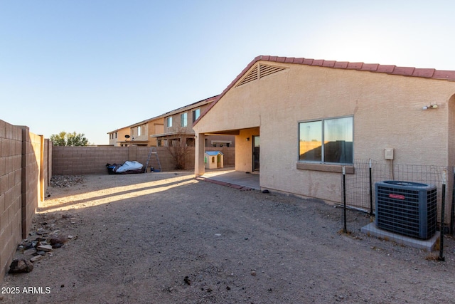 45 S 238th Dr, Buckeye, AZ 85396 - rear view of property with a patio, stucco siding, a fenced backyard, and central air condition unit