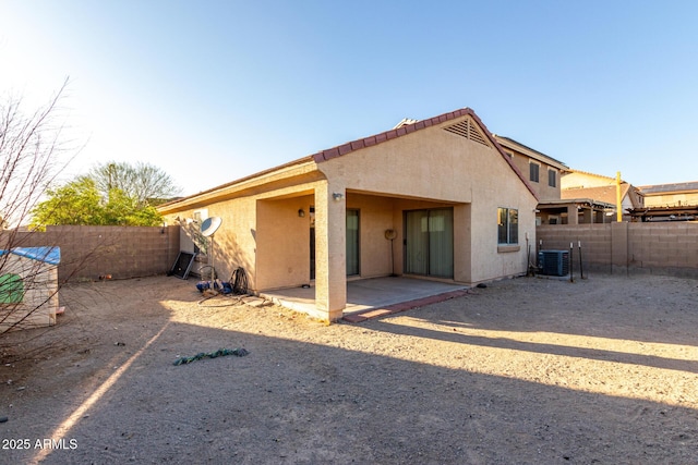 45 S 238th Dr, Buckeye, AZ 85396 - back of property featuring central AC unit, a patio area, a fenced backyard, and stucco siding