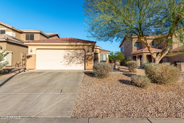 45 S 238th Dr, Buckeye, AZ 85396 - view of front facade featuring an attached garage, a tile roof, concrete driveway, and stucco siding