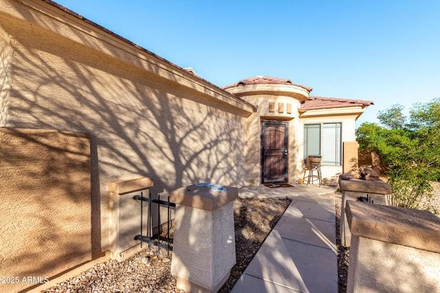 45 S 238th Dr, Buckeye, AZ 85396 - doorway to property featuring a tile roof and stucco siding