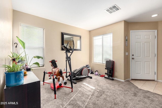 45 S 238th Dr, Buckeye, AZ 85396 - exercise area with light tile patterned floors, baseboards, visible vents, and light colored carpet