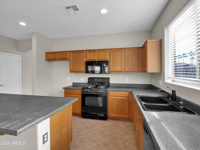 kitchen with black appliances, light tile patterned floors, and sink