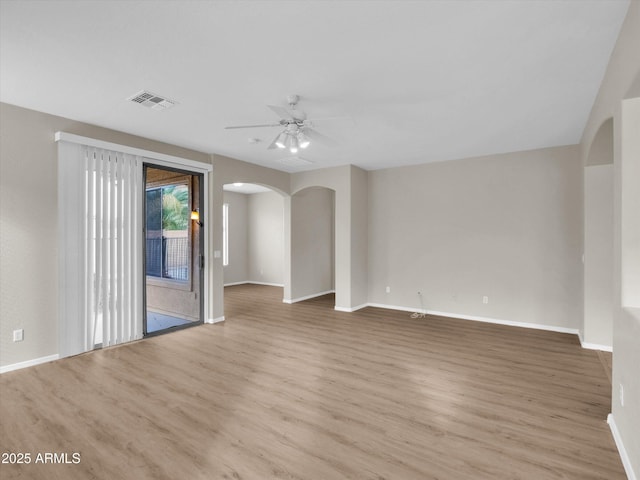 spare room with light wood-type flooring and ceiling fan