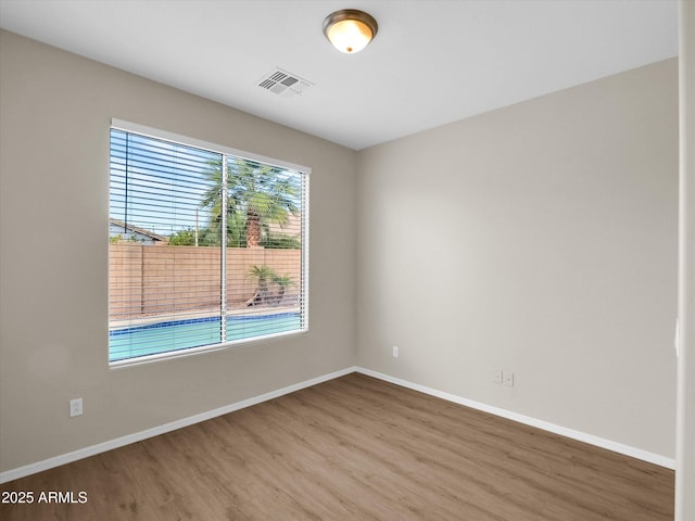 unfurnished room with wood-type flooring