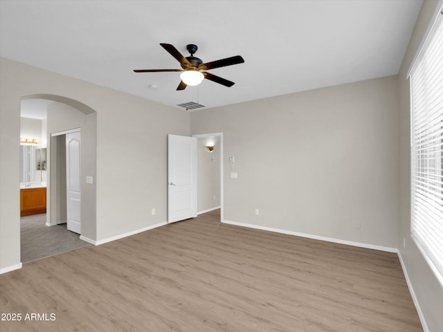 spare room with ceiling fan, a healthy amount of sunlight, and light wood-type flooring